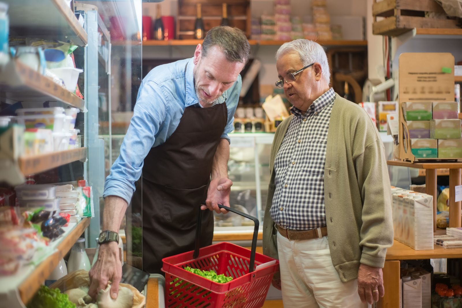 REACH Home Care caregiver carrying groceries into a senior client's home